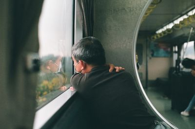 woman looking out the window of a train